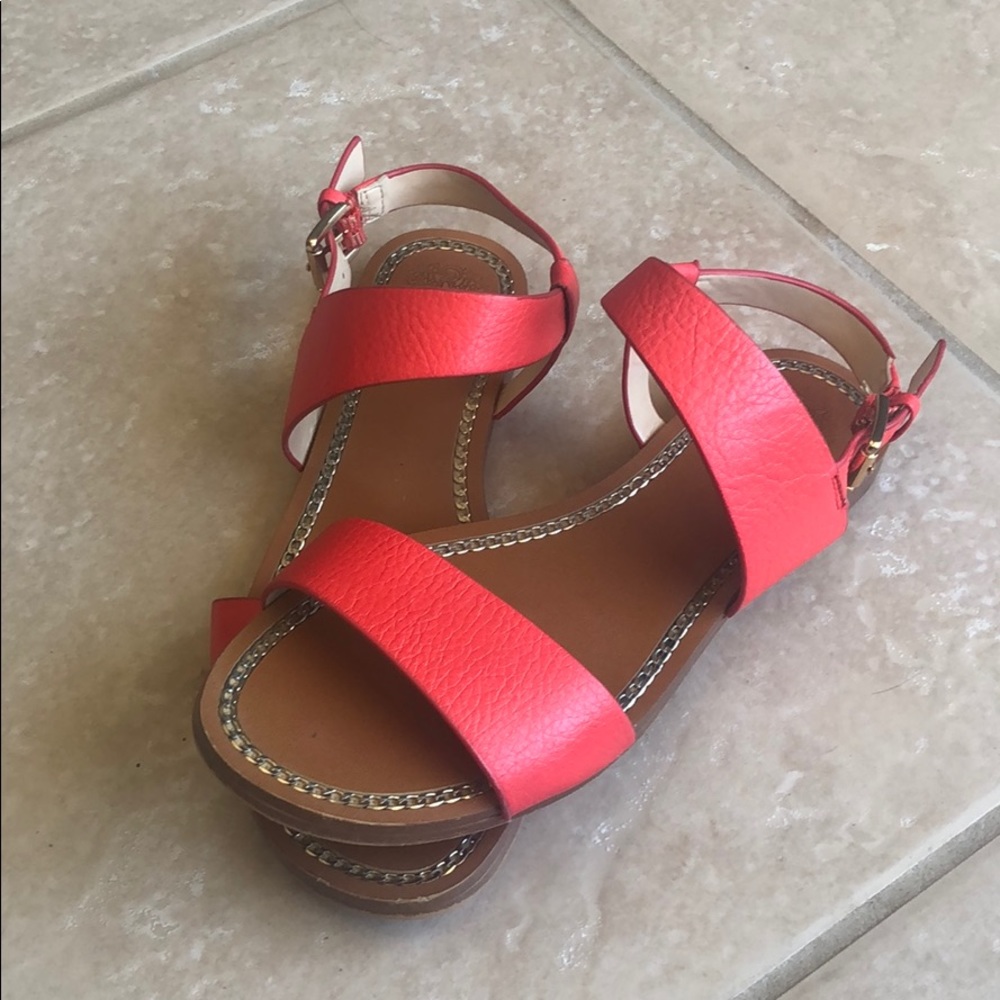 Red flat sandals with buckle closure